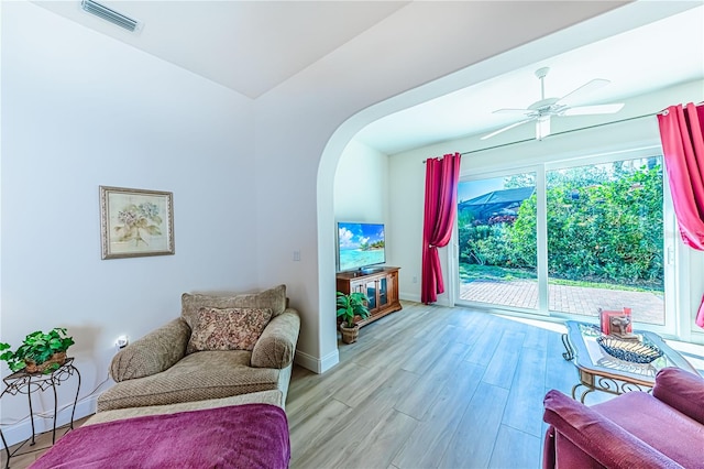 sitting room with ceiling fan and light hardwood / wood-style flooring