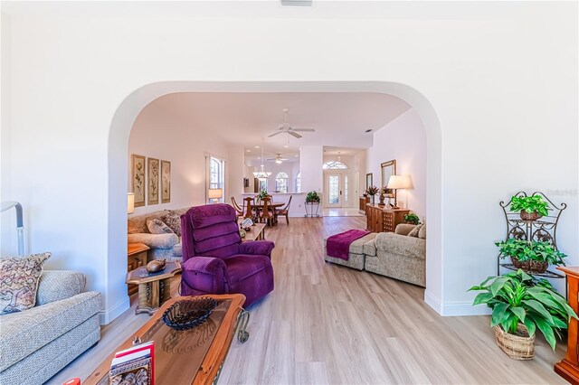 living room with light hardwood / wood-style flooring and ceiling fan