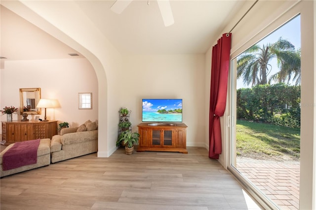 living room with ceiling fan, a healthy amount of sunlight, and light hardwood / wood-style flooring