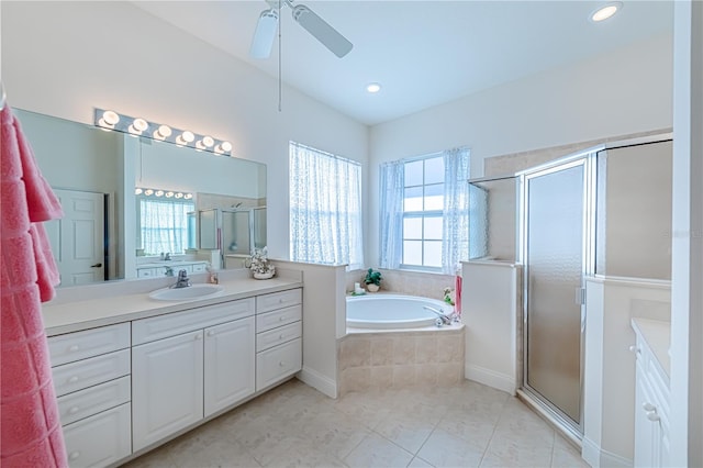 bathroom featuring tile patterned flooring, ceiling fan, vanity, and plus walk in shower