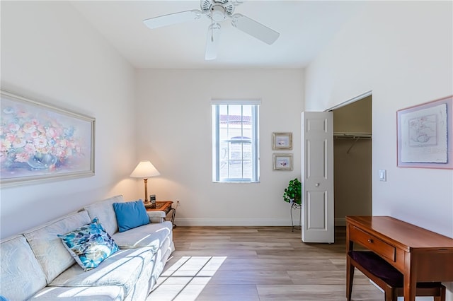 living room featuring light hardwood / wood-style flooring and ceiling fan