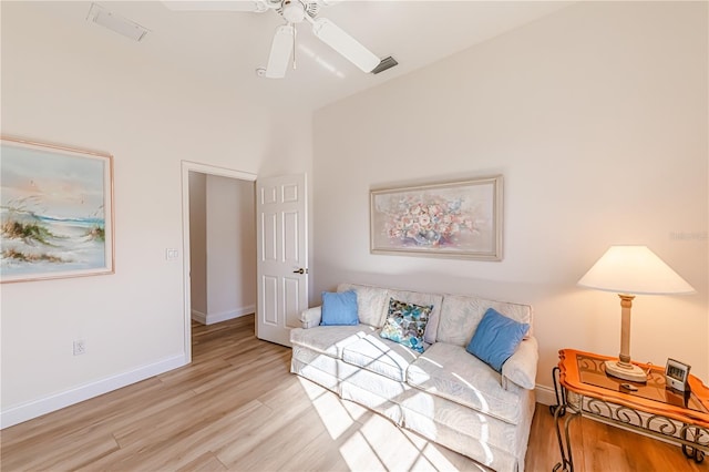 sitting room with ceiling fan and light hardwood / wood-style flooring