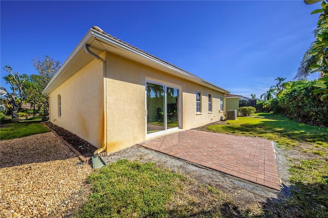 back of house with a yard, a patio, and central AC unit