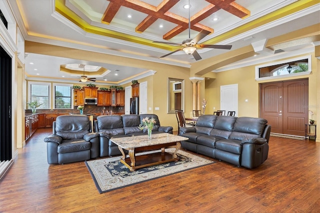 living room featuring decorative columns, coffered ceiling, and ornamental molding