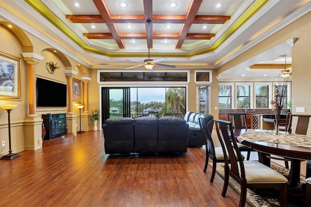 living room featuring coffered ceiling, dark hardwood / wood-style flooring, ornamental molding, and decorative columns