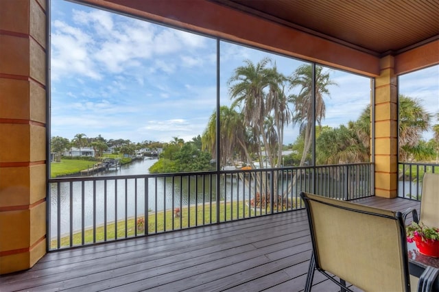 sunroom / solarium featuring a water view