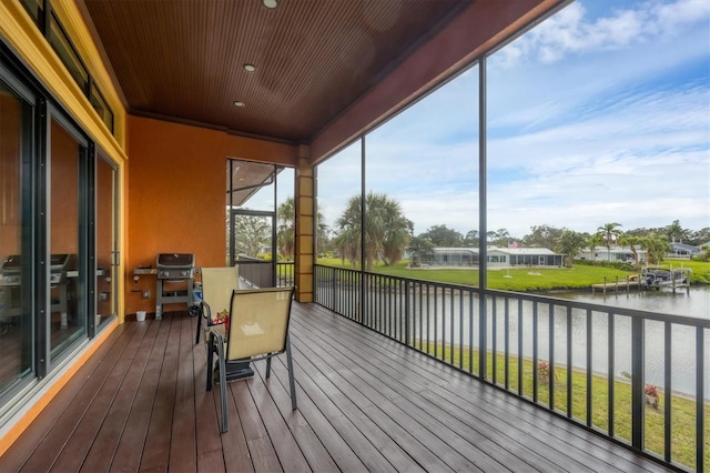 sunroom / solarium featuring a water view