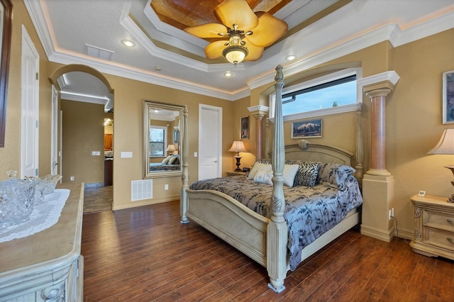 bedroom featuring dark hardwood / wood-style flooring, ornamental molding, and multiple windows