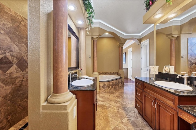 bathroom featuring a textured ceiling, vanity, ornate columns, and ornamental molding