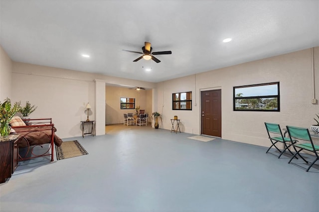 interior space featuring concrete floors and ceiling fan