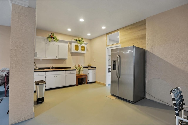 kitchen with white cabinetry, sink, and stainless steel refrigerator with ice dispenser