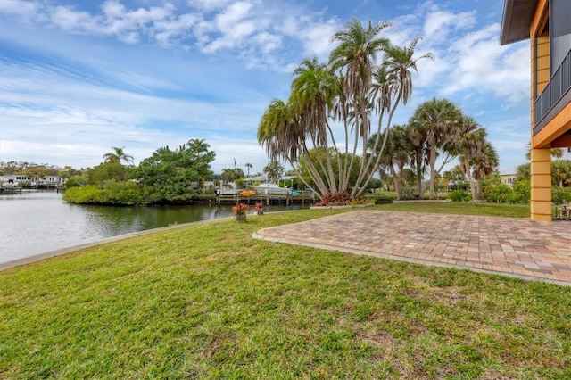 view of yard featuring a patio area and a water view