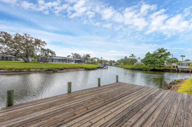 dock area featuring a yard and a water view