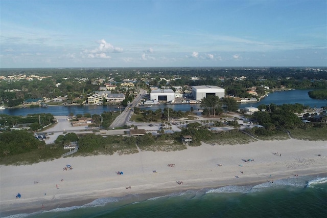 drone / aerial view featuring a water view and a view of the beach