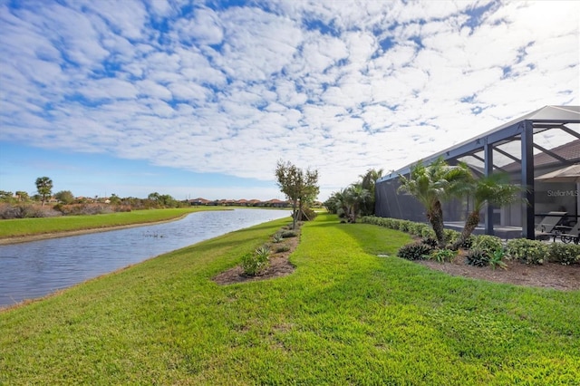 view of yard featuring glass enclosure and a water view