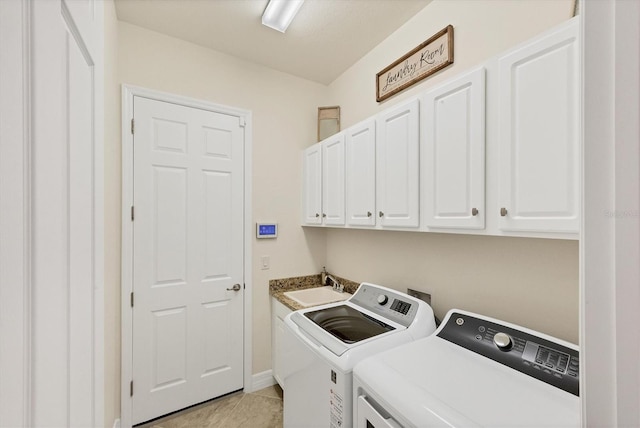 laundry area with washer and dryer, cabinets, light tile patterned floors, and sink