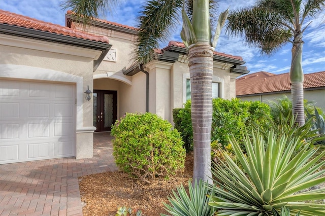 view of exterior entry featuring a garage