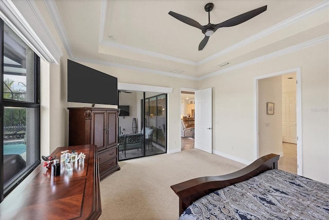 bedroom with a tray ceiling, ceiling fan, crown molding, and light carpet