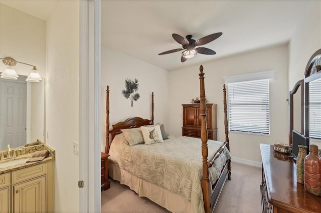 bedroom with ceiling fan, light carpet, and multiple windows