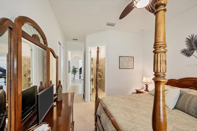 bedroom featuring ensuite bathroom, ceiling fan, and light colored carpet