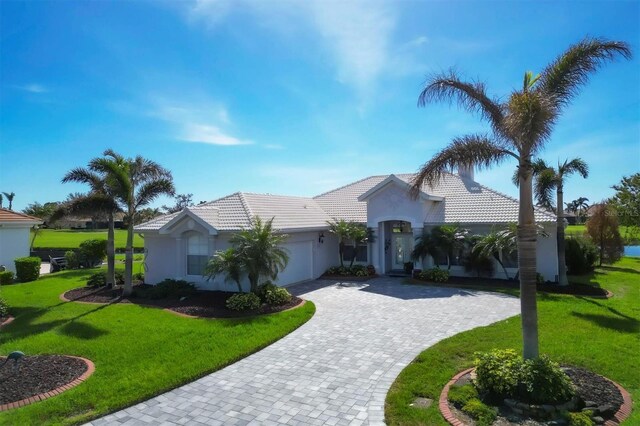 view of front of home featuring a garage and a front lawn