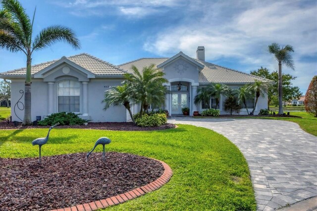 view of front facade featuring a front yard and french doors