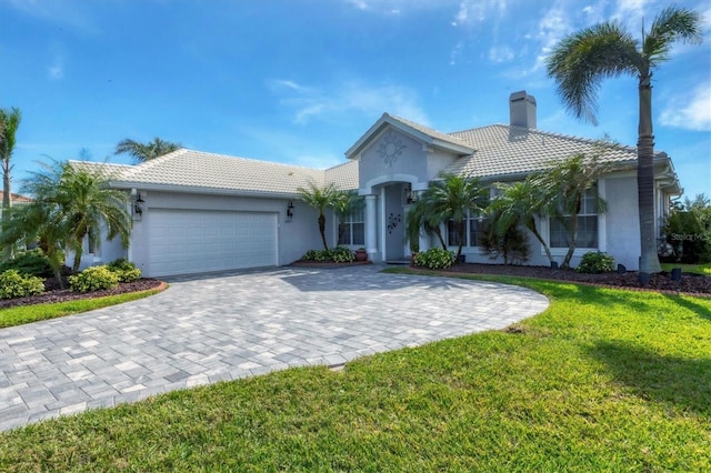 view of front facade featuring a front yard and a garage