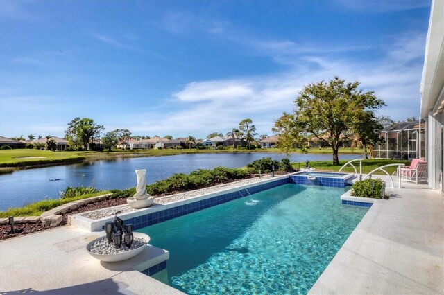 view of pool with a patio area, pool water feature, and a water view