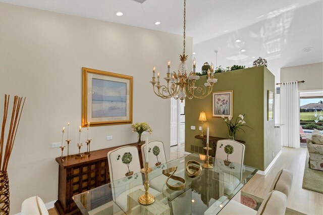 dining area with hardwood / wood-style floors and a chandelier