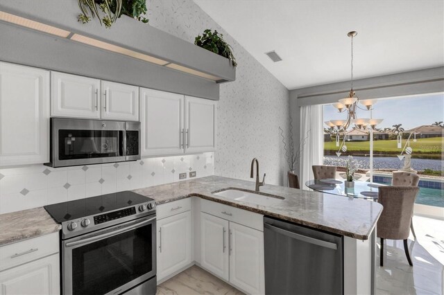 kitchen featuring kitchen peninsula, sink, white cabinetry, and stainless steel appliances