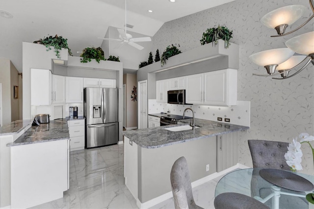 kitchen featuring kitchen peninsula, white cabinetry, ceiling fan, and stainless steel appliances