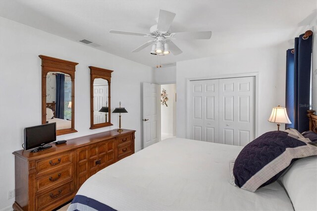 bedroom with ceiling fan and a closet