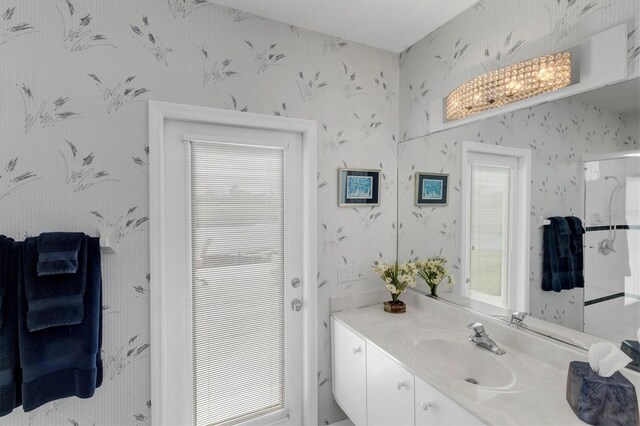 bathroom with plenty of natural light and vanity