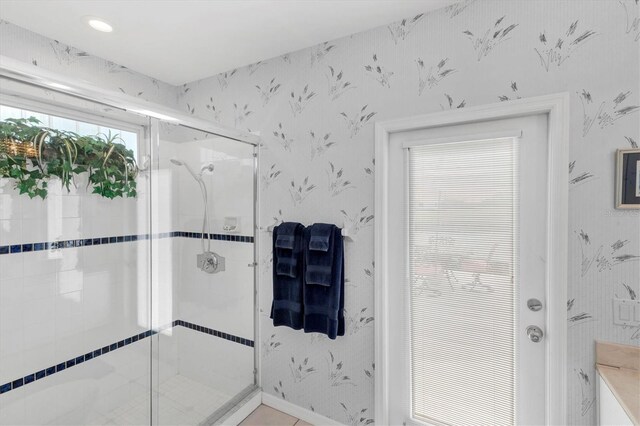 bathroom with a shower with door