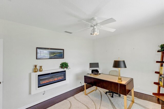 office area featuring dark hardwood / wood-style floors and ceiling fan