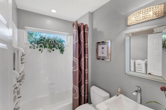 full bathroom featuring vanity, shower / tub combo, and toilet