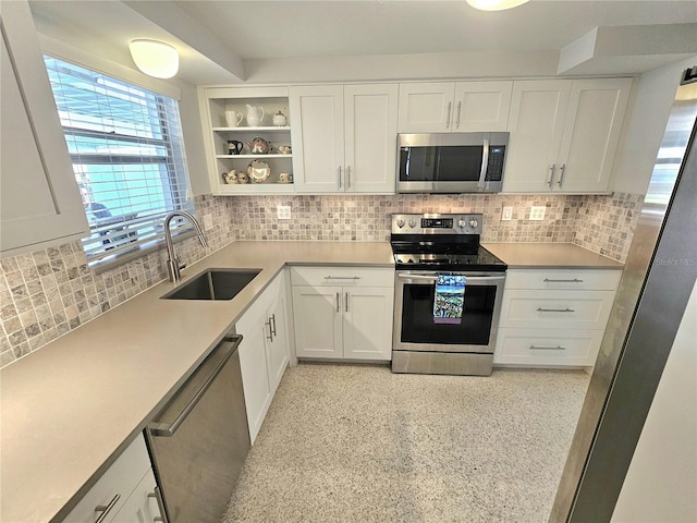 kitchen featuring backsplash, sink, white cabinets, and stainless steel appliances