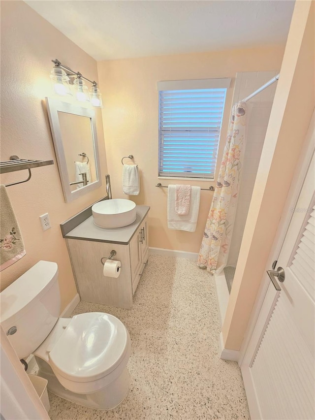 bathroom with vanity, toilet, and walk in shower