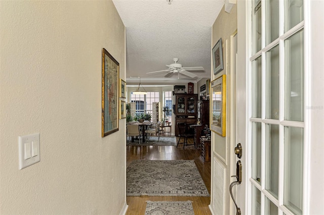 hall featuring hardwood / wood-style floors, a textured ceiling, and french doors