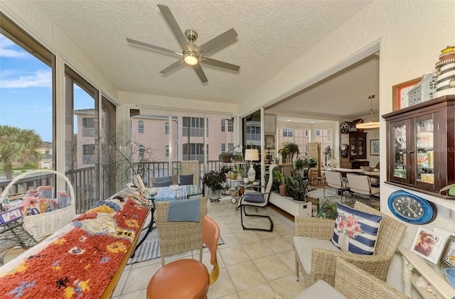 sunroom / solarium featuring ceiling fan