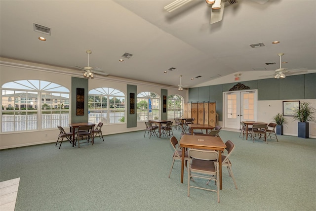 dining room with carpet flooring, vaulted ceiling, and plenty of natural light