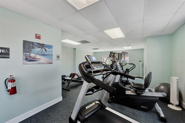 workout area with a paneled ceiling