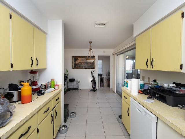 kitchen featuring pendant lighting, white dishwasher, and light tile patterned flooring