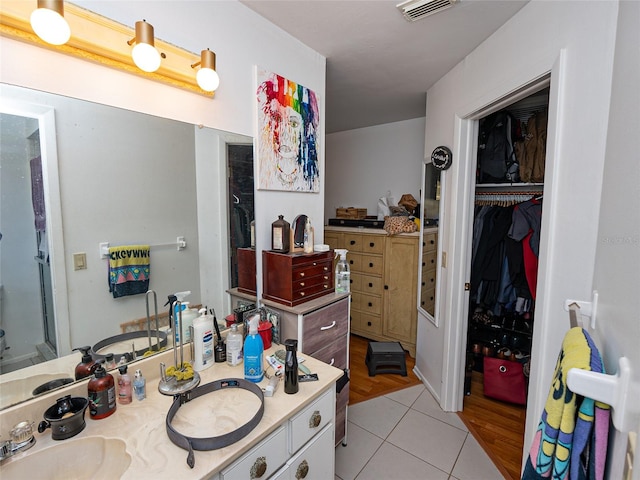 bathroom with tile patterned floors and vanity