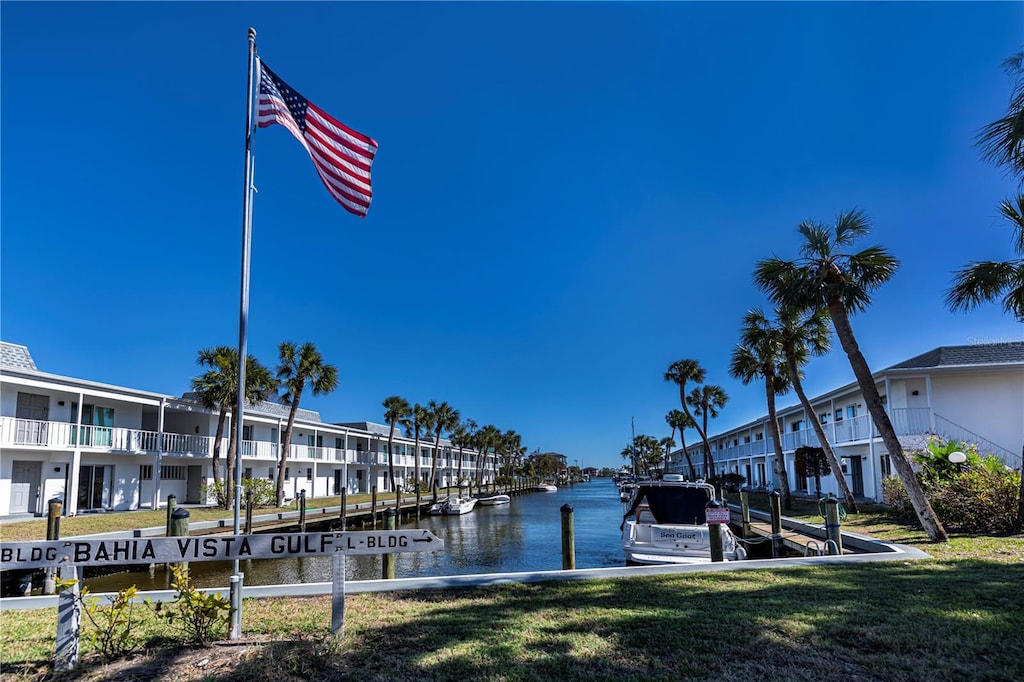 dock area featuring a water view and a lawn