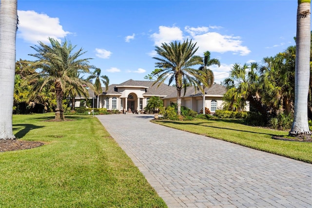 mediterranean / spanish-style house with a front yard