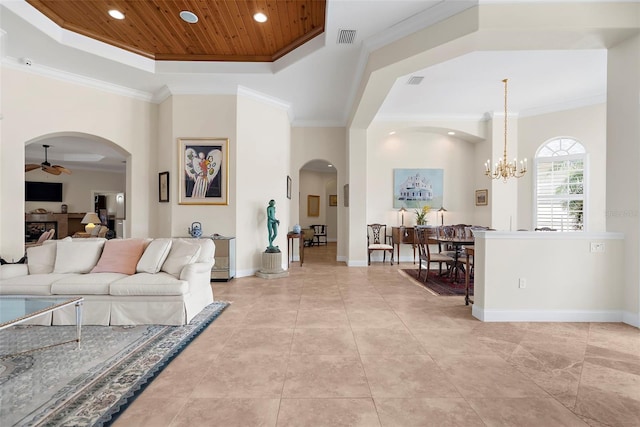 living room with ceiling fan with notable chandelier, a tray ceiling, ornamental molding, and wood ceiling