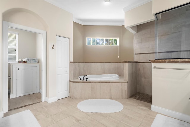 bathroom with plus walk in shower, tile patterned flooring, plenty of natural light, and ornamental molding