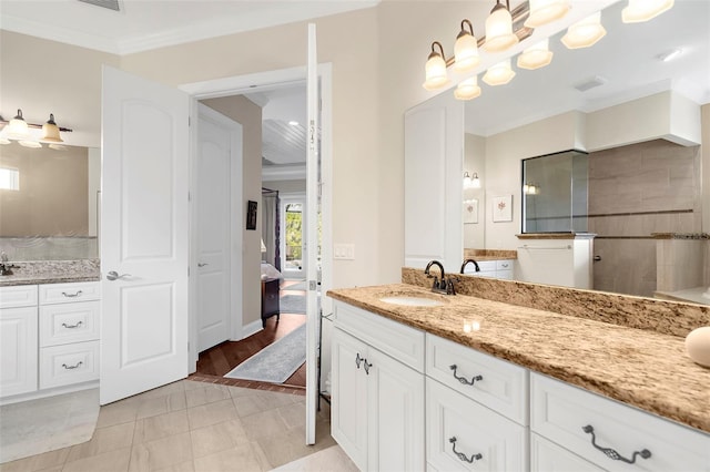 bathroom with vanity, ornamental molding, and walk in shower