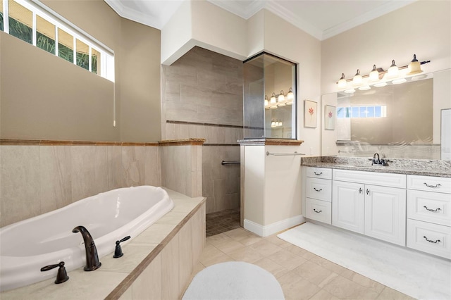 bathroom featuring tiled bath, crown molding, and vanity